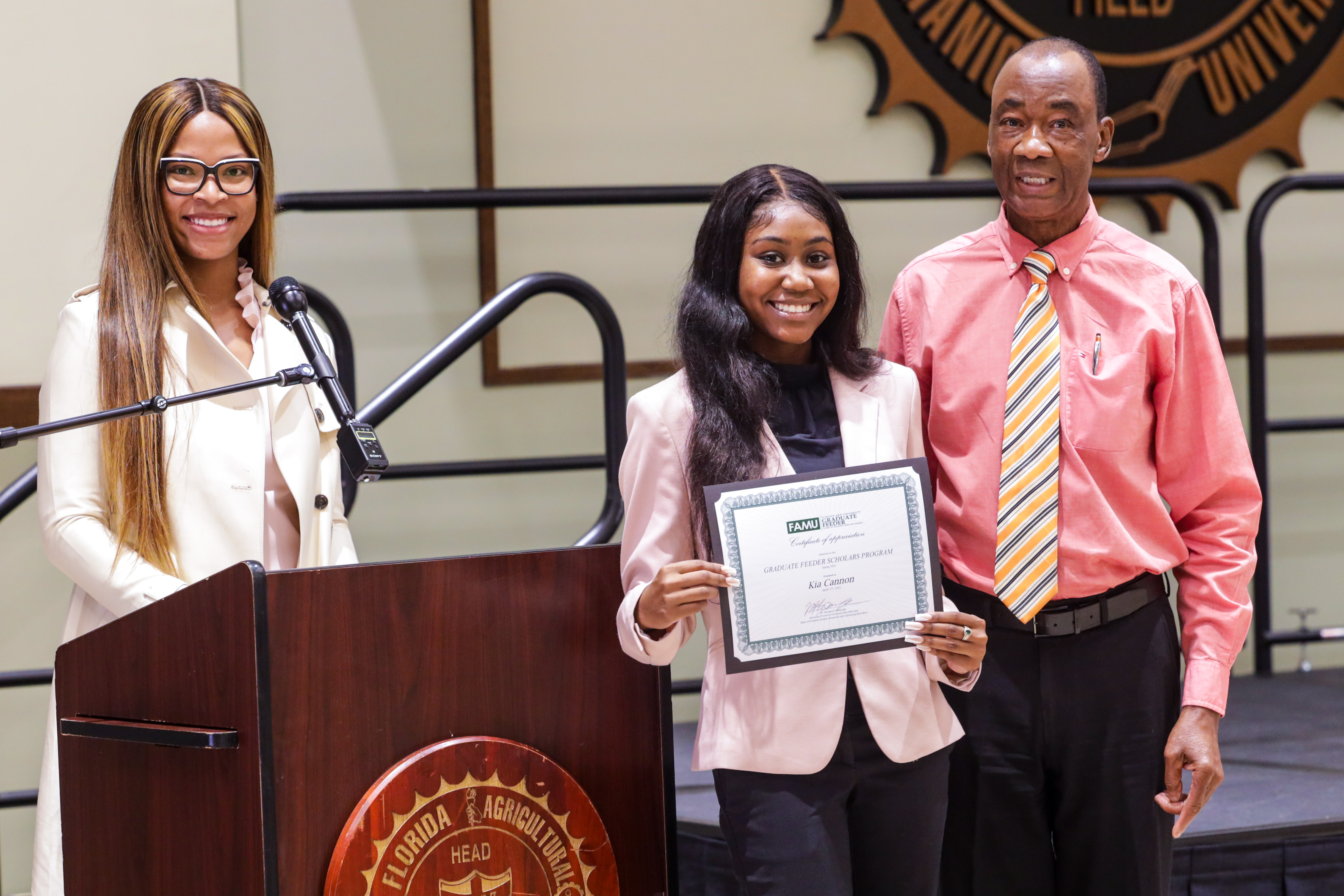 student receiving am award certificate.